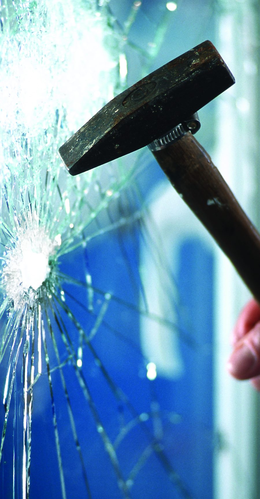 A hammer smashing a window